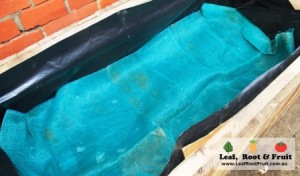 Use shadecloth to keep the planting soil from falling down into the water reservoir.